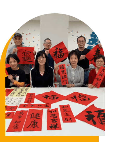 A group of people holding red paper with chinese writing on them.